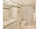 The bathroom has black and white patterned tiles, a bath and shower combo, and vanity at 14700 Gulf Blvd # 405, Madeira Beach, FL 33708
