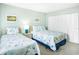 Bright bedroom with twin beds features colorful fish decor, carpeting, and closet at 14700 Gulf Blvd # 405, Madeira Beach, FL 33708