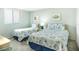 Bright bedroom with twin beds features colorful fish decor, carpeting, and sunny windows at 14700 Gulf Blvd # 405, Madeira Beach, FL 33708