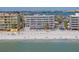 Beachfront condo building with lounge chairs and beach access at 14700 Gulf Blvd # 405, Madeira Beach, FL 33708