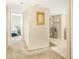 Hallway features include carpet, white walls, neutral tones, and entry to bedroom with twin bed at 14700 Gulf Blvd # 405, Madeira Beach, FL 33708