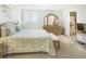 Tranquil main bedroom features large bed, seating bench, dresser, and view to ensuite bathroom at 14700 Gulf Blvd # 405, Madeira Beach, FL 33708