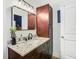 Well-lit bathroom featuring updated cabinets, a granite countertop, modern fixtures, and lots of storage at 1513 Woonsocket Ln, Brandon, FL 33511