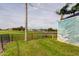 Backyard view with a pool mural and a glimpse of the surrounding community pond at 1547 Daylily Dr, Trinity, FL 34655