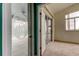 Bedroom doorway view featuring a glass etched sliding glass door for outdoor access to lanai at 1547 Daylily Dr, Trinity, FL 34655