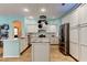 Modern kitchen featuring white cabinets, stainless steel appliances, and center island at 1547 Daylily Dr, Trinity, FL 34655