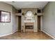 Spacious living room featuring decorative fireplace, neutral tones, and wood-look flooring at 1547 Daylily Dr, Trinity, FL 34655