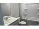 Well-lit bathroom with white vanity, marble countertop, and a shower-tub combination at 17036 James Trl, Parrish, FL 34219
