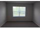 Cozy bedroom featuring a large window offering natural light and neutral wall color at 17036 James Trl, Parrish, FL 34219