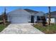 Charming single-story home featuring a brick-paved driveway and well-maintained landscaping at 17036 James Trl, Parrish, FL 34219