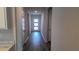Bright hallway with a clear view of the front door, showcasing natural light and an open floor plan at 17036 James Trl, Parrish, FL 34219