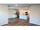 Open-concept kitchen features an island, stainless steel appliances and hardwood floors at 17036 James Trl, Parrish, FL 34219
