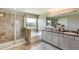 Bright bathroom with tiled shower, white cabinetry, granite countertops, and double sink at 1741 Cobb Trl, Parrish, FL 34219