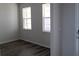 Bright bedroom with stylish flooring, two windows and ample natural light at 1741 Cobb Trl, Parrish, FL 34219