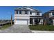 Charming two-story home with a paved driveway, manicured lawn, and a two-car garage at 1741 Cobb Trl, Parrish, FL 34219