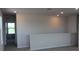 Bright hallway with neutral walls leading to an open view through a window at 1741 Cobb Trl, Parrish, FL 34219