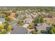 Expansive aerial view of a residential neighborhood with manicured lawns, mature trees, and well-maintained homes at 182 Dahoon Ct, Spring Hill, FL 34609