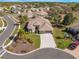 Scenic aerial view of a well-kept neighborhood with winding streets, mature trees, and beautifully landscaped yards at 182 Dahoon Ct, Spring Hill, FL 34609