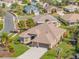 Well-maintained single-Gathering home with lush landscaping, a spacious driveway, and a screened-in garage at 182 Dahoon Ct, Spring Hill, FL 34609