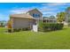 Enclosed lanai with a manicured lawn, flowering bushes and manicured shrubs offer privacy to this home's backyard at 182 Dahoon Ct, Spring Hill, FL 34609
