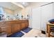 Bathroom with a double sink vanity, large mirror, wood cabinets, and tile floor at 182 Dahoon Ct, Spring Hill, FL 34609