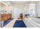 Bright bathroom featuring a soaking tub, glass-enclosed shower, and double sink vanity at 182 Dahoon Ct, Spring Hill, FL 34609