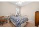 Cozy bedroom with white iron bed frame and blue floral bedding, offering a peaceful and inviting space at 182 Dahoon Ct, Spring Hill, FL 34609