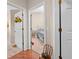 Open doorways lead to a serene bedroom with white furniture and floral bedding at 182 Dahoon Ct, Spring Hill, FL 34609