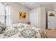 Cozy bedroom featuring neutral walls, a bed with a patterned comforter and a sunflower painting at 182 Dahoon Ct, Spring Hill, FL 34609