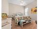 Bright bedroom with sunflower accents, a decorative bed, bench, and neutral walls at 182 Dahoon Ct, Spring Hill, FL 34609