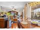 Open-concept kitchen featuring breakfast nook with wooden table, adjacent to the living area at 182 Dahoon Ct, Spring Hill, FL 34609