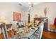 Chic dining room with a glass table, seating for six, and stylish decorative features at 182 Dahoon Ct, Spring Hill, FL 34609