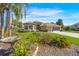 Charming single-story home featuring a paver driveway, mature landscaping, and a welcoming facade at 182 Dahoon Ct, Spring Hill, FL 34609