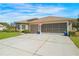 This home boasts an attached two car garage, neutral exterior paint and paver driveway, and manicured lawn at 182 Dahoon Ct, Spring Hill, FL 34609