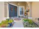 Inviting front porch with stylish decorations, plants, and seating area that adds to its charm at 182 Dahoon Ct, Spring Hill, FL 34609