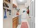 Laundry room with washer, dryer, storage shelves and wall hooks for added convenience at 182 Dahoon Ct, Spring Hill, FL 34609