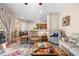 Comfortable seating, colorful rug, wood flooring, and access to the dining area at 182 Dahoon Ct, Spring Hill, FL 34609