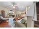 Bright living room featuring hardwood floors, ceiling fan and sliding door to outdoor lanai at 182 Dahoon Ct, Spring Hill, FL 34609