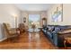 Comfortable living room with hardwood floors, a large window, and cozy seating arrangement at 182 Dahoon Ct, Spring Hill, FL 34609