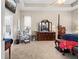Spacious main bedroom with a carpeted floor, a ceiling fan, and a sitting area with a dresser at 182 Dahoon Ct, Spring Hill, FL 34609