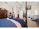 Large main bedroom featuring a four-poster bed, carpeted floor, and adjacent rooms at 182 Dahoon Ct, Spring Hill, FL 34609