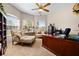 Bright office with a large desk, comfortable sitting area, and windows offering natural light at 182 Dahoon Ct, Spring Hill, FL 34609