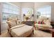 Comfortable office sitting area with armchairs, ottoman, side table, and large windows providing natural light at 182 Dahoon Ct, Spring Hill, FL 34609