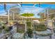 Inviting screened lanai with an outdoor dining table and comfortable lounge chairs, perfect for relaxing at 182 Dahoon Ct, Spring Hill, FL 34609