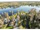 Aerial view showcases the community's placement amongst mature trees on the shoreline of a large lake at 19230 Lake Allen Rd, Lutz, FL 33558