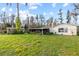 Expansive backyard featuring a lush lawn, mature trees, and a screened-in porch for outdoor enjoyment at 19230 Lake Allen Rd, Lutz, FL 33558
