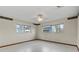 Bright bedroom featuring two large windows and a ceiling fan at 19230 Lake Allen Rd, Lutz, FL 33558