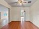 Well-lit dining area with wood floors and a ceiling fan at 19230 Lake Allen Rd, Lutz, FL 33558