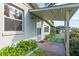 Charming home exterior showcasing a covered entry and landscaped walkway at 19230 Lake Allen Rd, Lutz, FL 33558