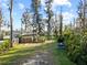 Lush lawn and mature trees provide a peaceful setting at 19230 Lake Allen Rd, Lutz, FL 33558